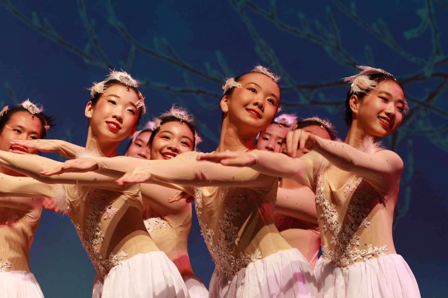 A group of women dances on stage at a Lunar New Year's celebration